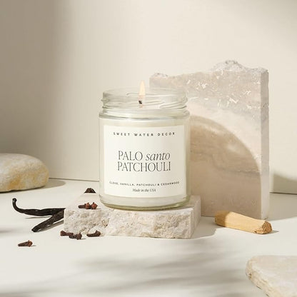 Sweet Water Decor Palo Santo Patchouli Candle - Soy Clove, Vanilla, Patchouli, Cedarwood Scented Spa Candles for Home -9oz Clear Jar + Gold Lid, 40+ Hour Burn Time, Made in The USA